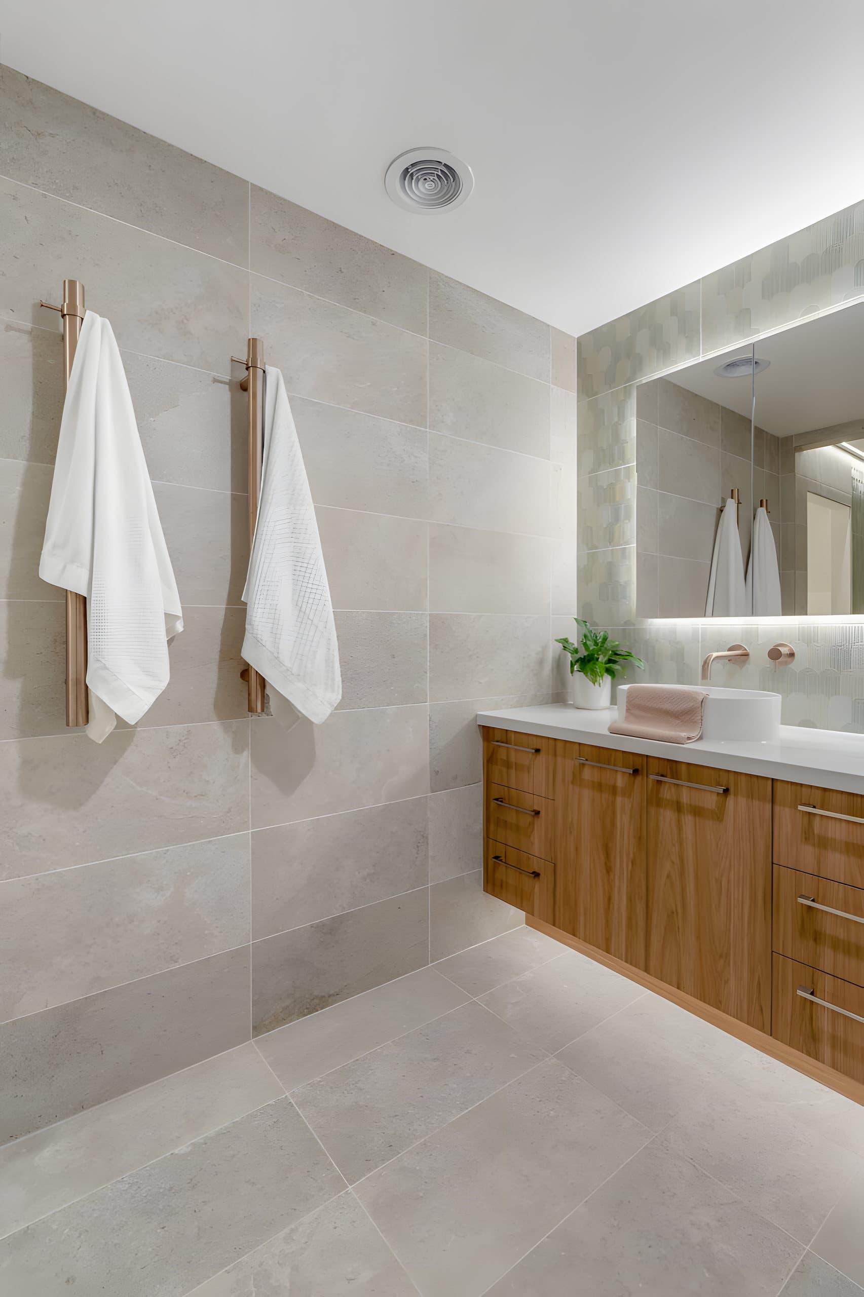 Stone-look wall tiles and timber vanity