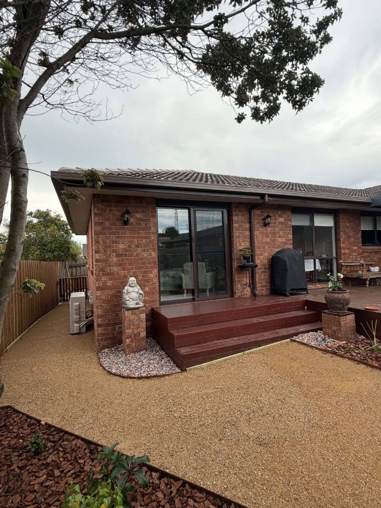 Brick home with rear deck and garden